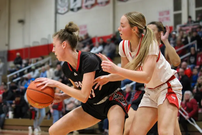 Basketball player protecting the ball against a defender