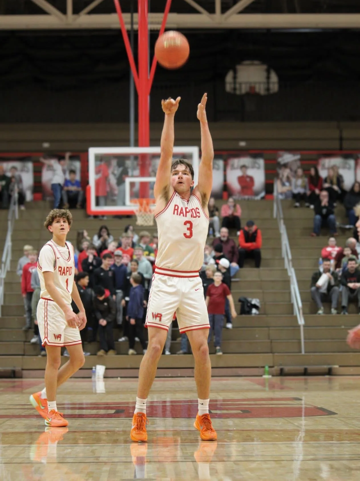 Basketball player rising toward the hoop for a shot